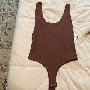 stretchy very open back and low cut on sides chocolate brown body suit tags on